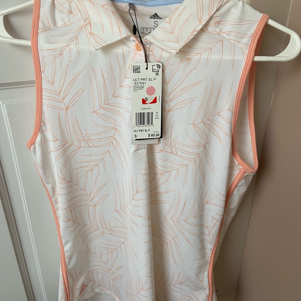 Adidas sleeveless golf polo. White with soft pink pattern. Size small
